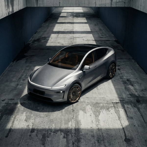Graues Tesla Model Y Juniper mit CHELA Felgen in Matte Bronze und Satin Carbon, von oben in moderner Umgebung fotografiert.