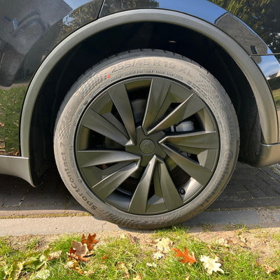 Tesla Model Y Juniper mit schwarzen 19 Zoll Helix-Radkappen – perfekte Passform, verbesserte Aerodynamik und elegante Optik in schwarz.
